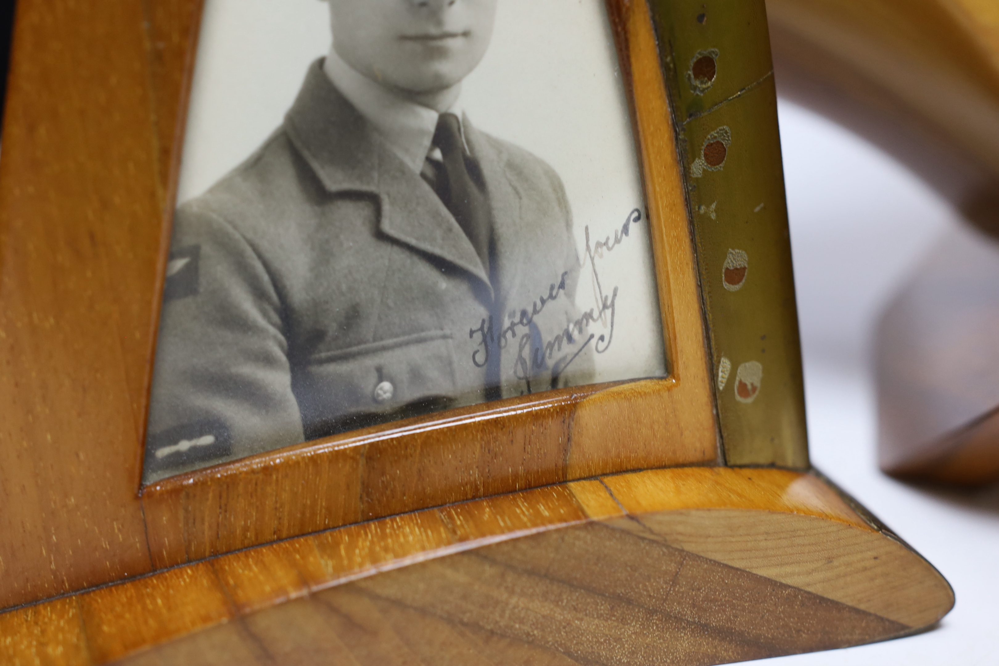 A WWII wooden propeller clock case, reputedly from a Spitfire related photo frame housing a black and white photograph of a soldier together with a trinket box, 35cm wide
